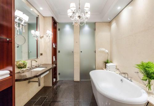 a bathroom with a tub and a sink and a mirror at Palacio Duhau - Park Hyatt Buenos Aires in Buenos Aires