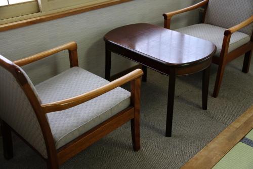 a table and two chairs and a table and a table at Hotel Yuzawa Yuzawa Denkiya in Yuzawa