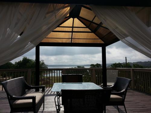 a patio with a table and chairs on a deck at Lodge At Turkey Cove in Canyon Lake