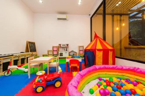 a play room with a toy truck and a tent at The Gallery Hotel Nai Harn in Nai Harn Beach