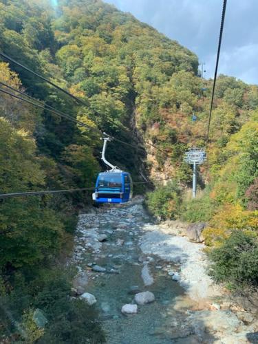 a blue car on a ski lift in a mountain at KKR Yuzawa Yukiguni in Yuzawa