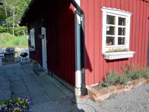 a red house with a window and a flower box at Ynde Private Apartment in Sölvesborg