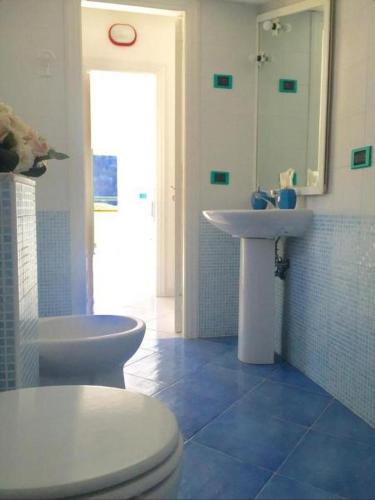 a bathroom with a toilet and a sink at Relais del mare con terrazza fronte mare free parking in Massa Lubrense