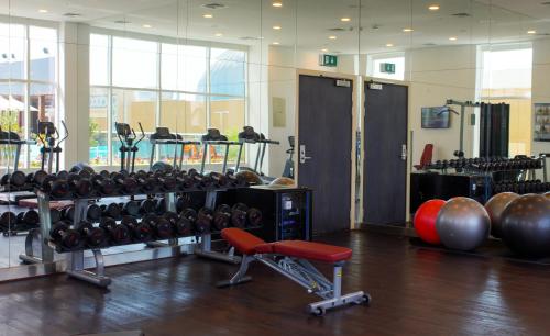 a gym with dumbbells and weights in a room at Premier Inn Dubai Ibn Battuta Mall in Dubai