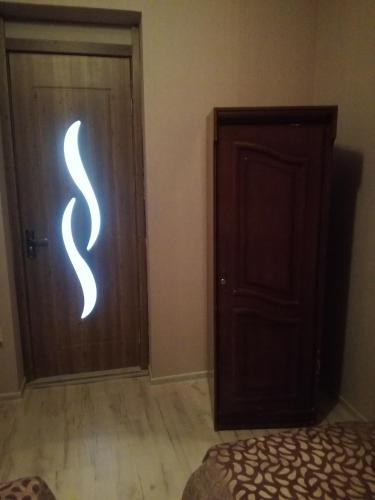 a bedroom with a door with a snake painted on it at happy pandasN12 in Borjomi