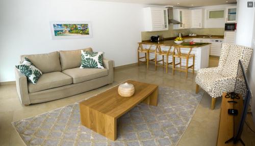 a living room with a couch and a table at The Quadrant Luxury Apartments in Victoria