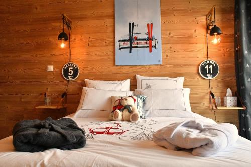 a bedroom with a bed with a teddy bear on it at Le Skidoux in LʼHuez