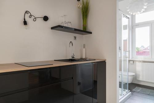 a kitchen with a counter top and a sink at Modern studio in the heart of the city in Maribor