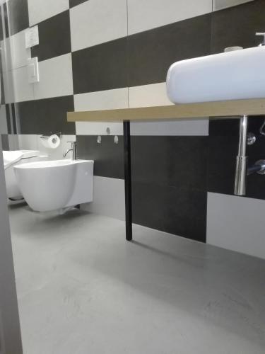 a bathroom with a sink and a tub and a toilet at Patio 101 "Exclusive" in San Vito lo Capo