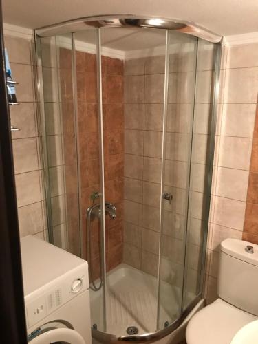 a shower stall in a bathroom next to a toilet at Afytos house in Afitos