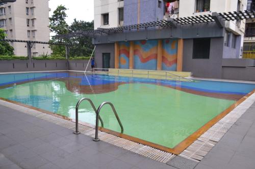 a large swimming pool in a building at Princeton Club in Kolkata