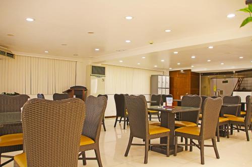 a dining room with tables and chairs in a restaurant at World View Pension House in Dumaguete