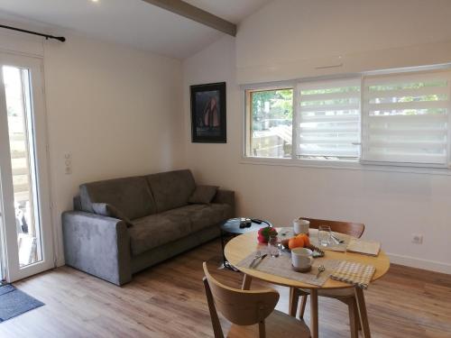 a living room with a couch and a table at Hossegor Les Bécasses in Soorts-Hossegor