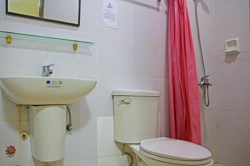 a bathroom with a toilet and a sink at World View Pension House in Dumaguete