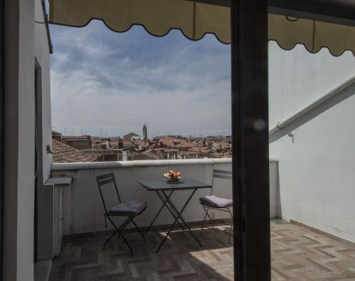 a balcony with a table and chairs and a view at Ca'Baloni in Venice