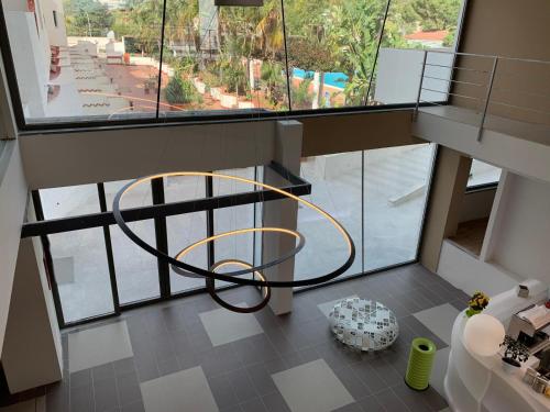 a room with a large window and a circular chair at Saracen Sands Hotel & Congress Centre - Palermo in Isola delle Femmine