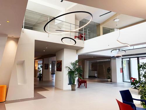 a lobby of a building with a potted plant at Saracen Sands Hotel & Congress Centre - Palermo in Isola delle Femmine