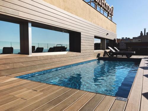 a swimming pool on top of a building at Hotel Metropol in Lloret de Mar