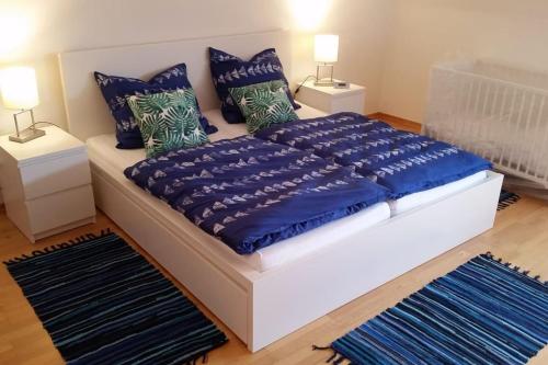 a bedroom with a bed with blue sheets and pillows at Altstadtflair in Stolberg