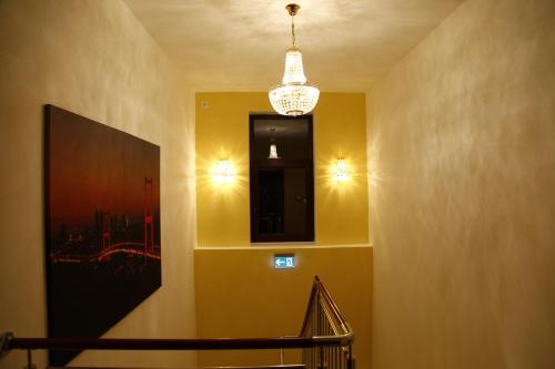 a hallway with a staircase and a chandelier at Hotel City Inn Hamburg-Mitte in Hamburg