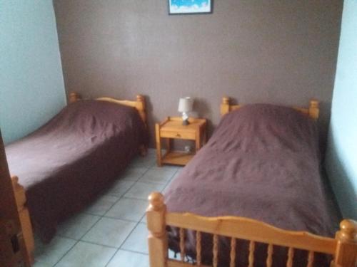 2 Betten in einem kleinen Zimmer mit ermottermottermott in der Unterkunft villa rue gainekoa 1er étage in Cambo-les-Bains