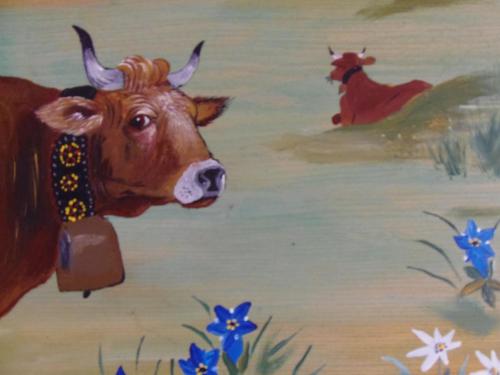 a painting of a cow in a field with blue flowers at Chalet l'aubépine résidence B&B in Bessans