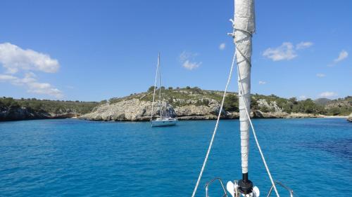 a sail boat in the water with a boat at Finca Son Blat in Porto Cristo