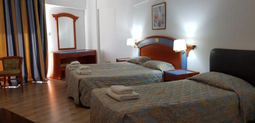 Un pat sau paturi într-o cameră la Petalmo City Apartments