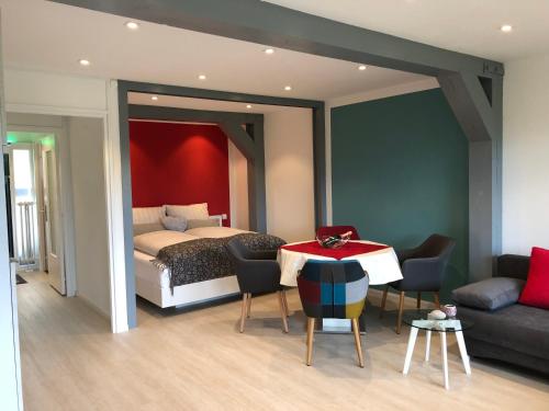 a bedroom with a bed and a table and a couch at Ferienanlage Vorauf - be lucky in Siegsdorf