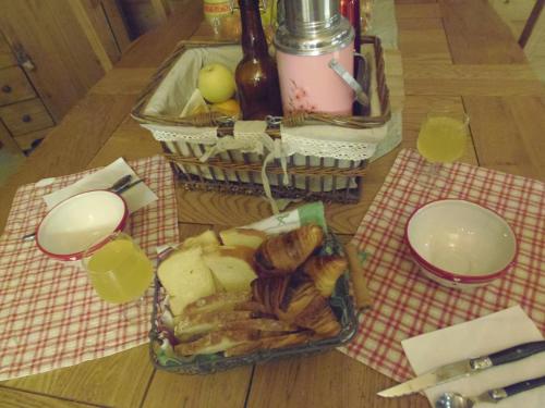 a table with a tray of bread and baskets of food at Chalet l'aubépine résidence B&B in Bessans