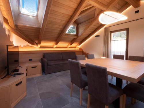 a kitchen and dining room with a wooden table and chairs at Chalet Stella Alpina in Val di Zoldo