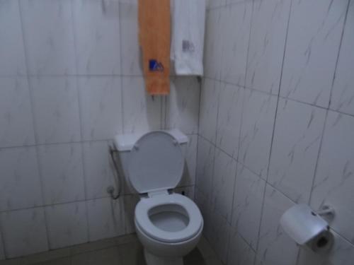 a bathroom with a toilet and a toilet paper dispenser at Meka Hotel in Kara