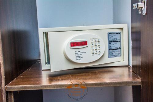a microwave oven sitting on a wooden shelf at Grand Winston Hotel in Nakuru