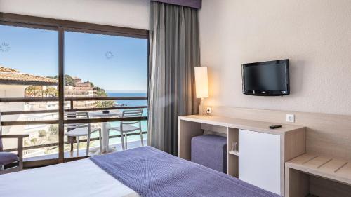 a hotel room with a bed and a view of the ocean at Hotel Be Live Adults Only Marivent in Palma de Mallorca