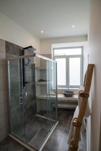 a glass shower in a bathroom with a window at Ederlezi Boutique Hotel in Athens