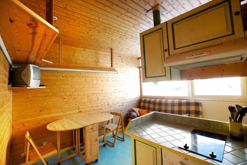 a kitchen with a table and a counter top at Appartement la Cabane d'Engaly in Aragnouet
