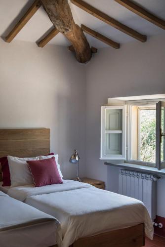 a bedroom with two beds and a window at Bioagriturismo il cerreto in Pomarance