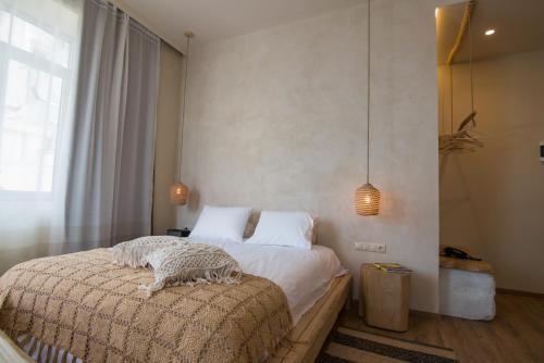 a bedroom with a large bed in a room at Ederlezi Boutique Hotel in Athens
