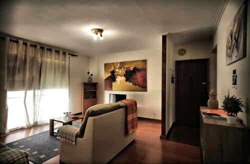 a living room with a couch and a table at Canto da Maia Apartment in Ponta Delgada