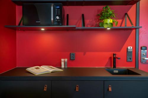 a kitchen with a counter with a microwave and a sink at Via Suites in Amsterdam