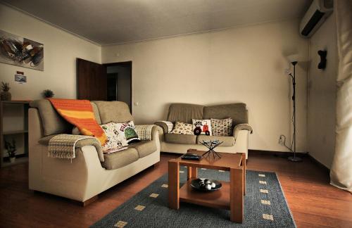 a living room with two couches and a coffee table at Canto da Maia Apartment in Ponta Delgada