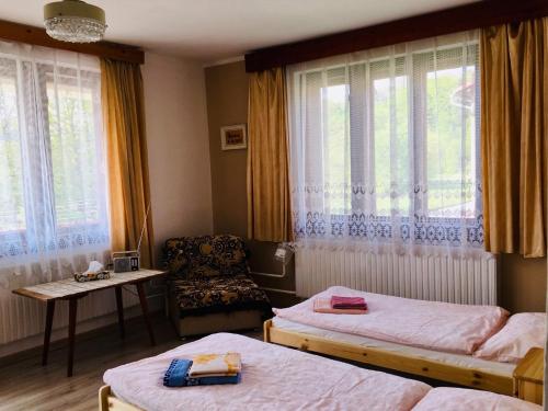 a hotel room with two beds and a chair at Rodinný RETRO domček in Dolný Kubín