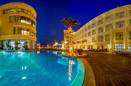 a hotel with a swimming pool in front of a building at Sousse Palace Hotel & Spa in Sousse