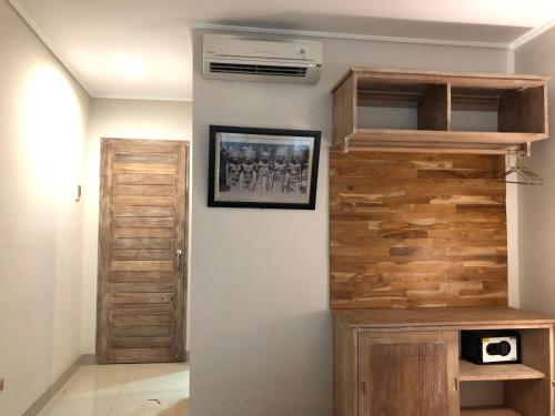 a room with a wooden wall with a air conditioner at Betutu Bali Villas in Ubud