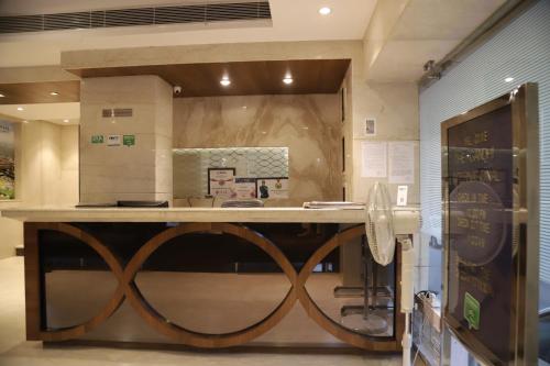 a kitchen with a counter with a wooden counter top at The Gandhi International in Jodhpur