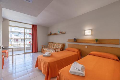 a hotel room with two beds and a window at Salou Pacific Rentalmar in Salou