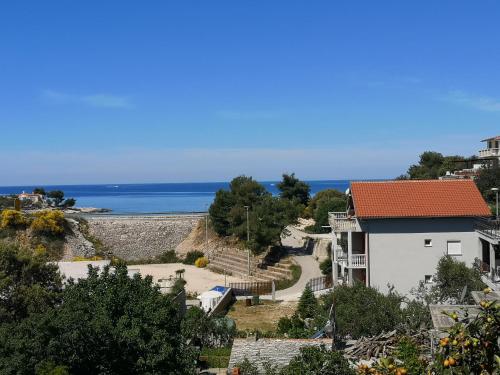 a view of the ocean from a house at Apartman Sissy in Primošten