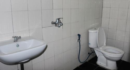 a bathroom with a sink and a toilet at FX72 Beach Resort Maumere in Maumere