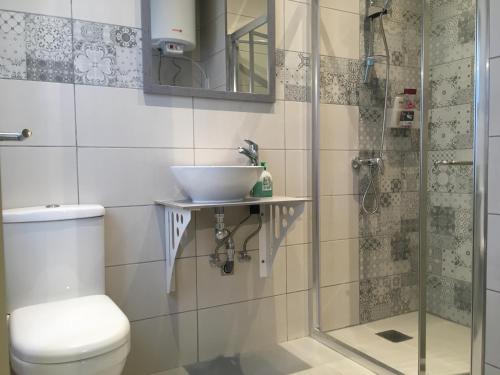 a bathroom with a sink and a toilet and a shower at Seaside Room in Msida