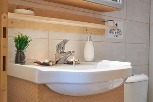 a bathroom with a sink with candles on it at Pearl Apartments in Ofrínion